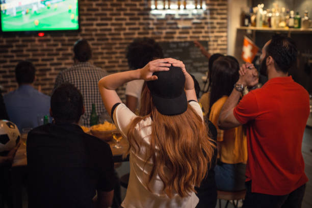 What is a must-visit Dallas bar with massive displays for sports enthusiasts?